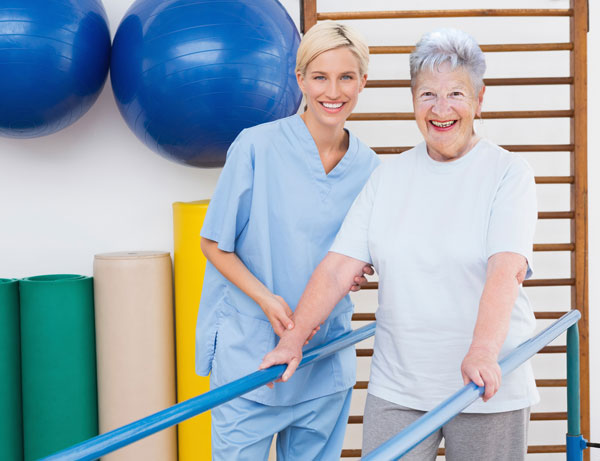 Portrait of nurse and patient in rehabilitation gym.